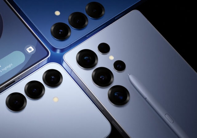 The Samsung Galaxy S25, S25 Plus, and S25 Ultra next to each other laying face down with a fourth phone showing an AI prompt on the lock screen